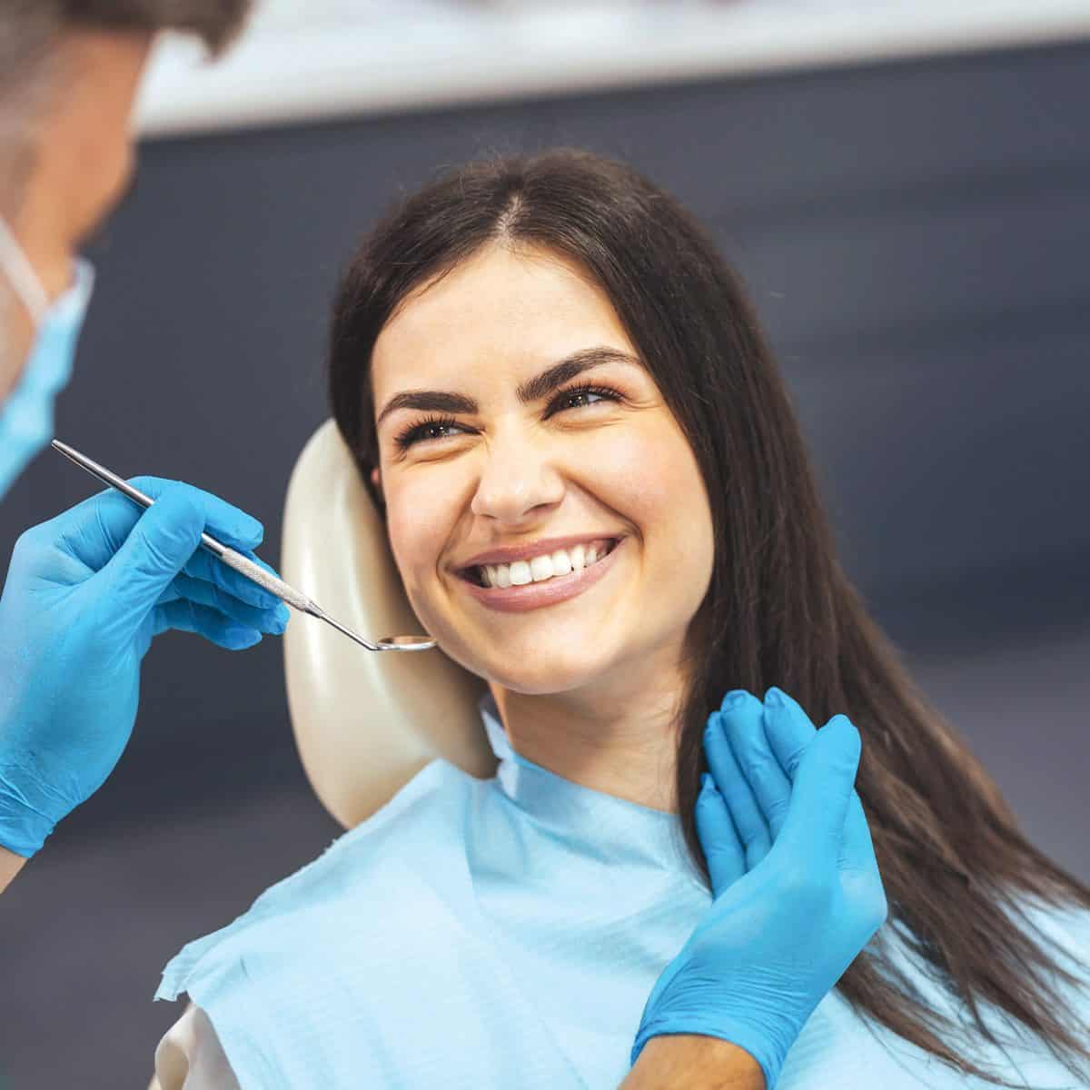 smiling patient looking at her dentist