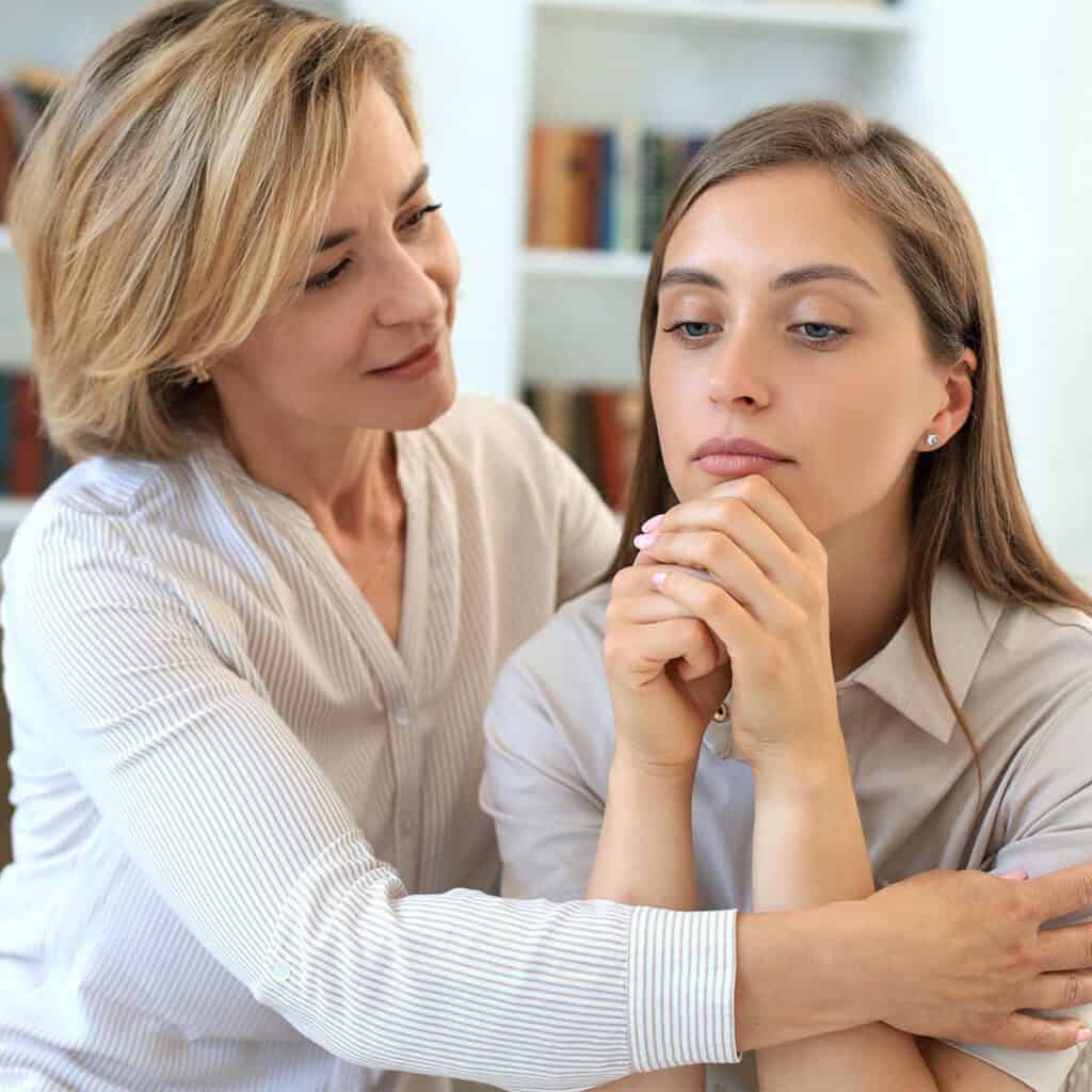 middle-aged mother hugging her daughter