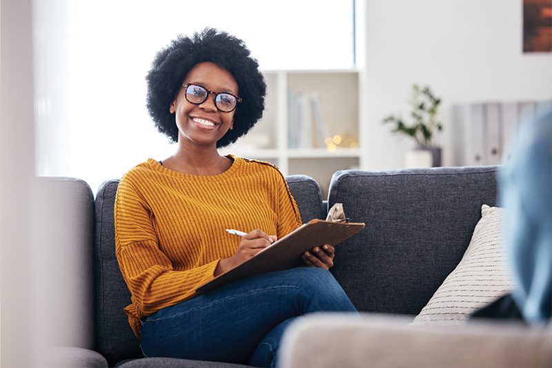 woman with clipboard smiling