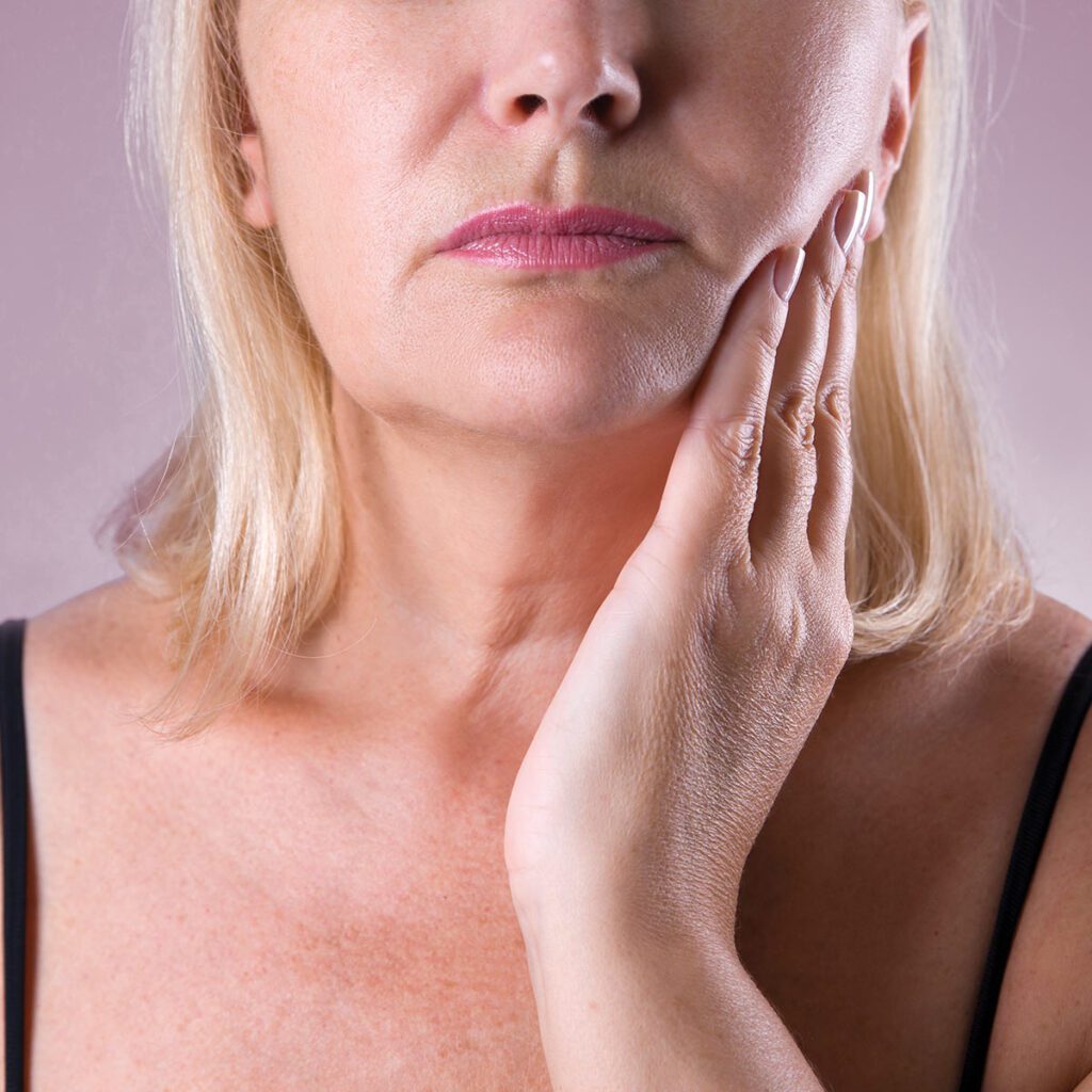 woman expressing pain in her jaw