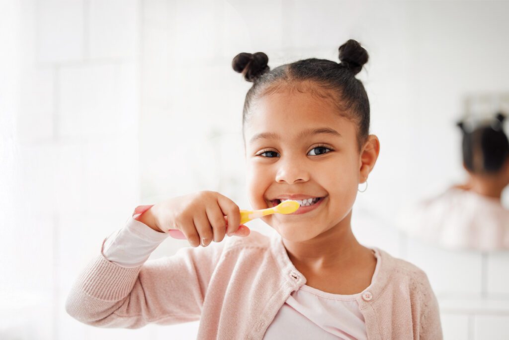 girl brushing her teeth