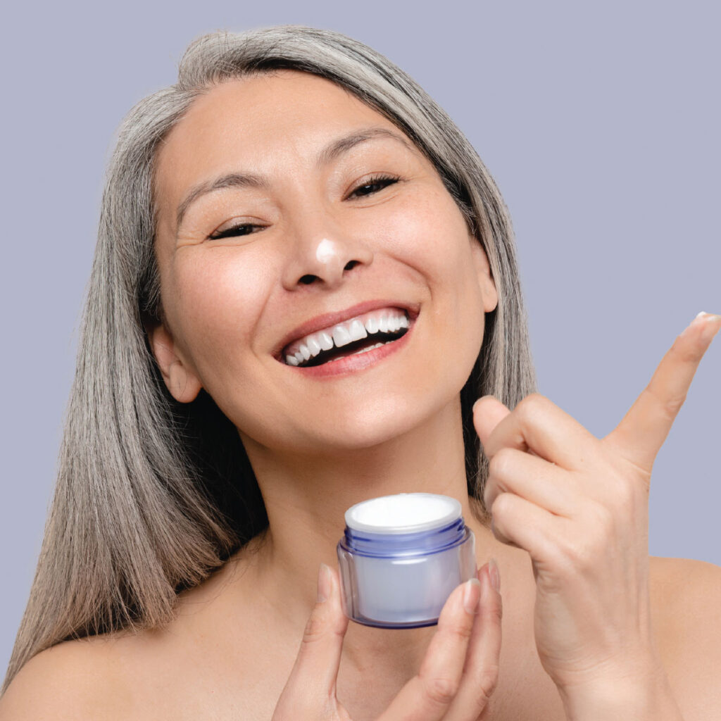 woman applying moisturizer