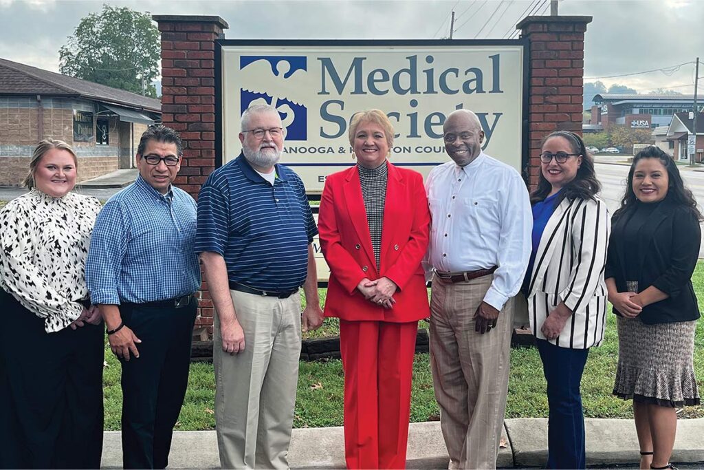 project access employees standing in front of company sign