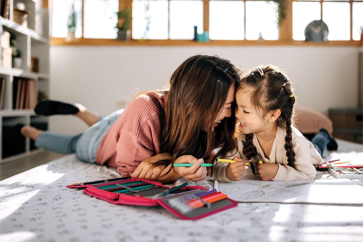 Mother and daughter coloring together