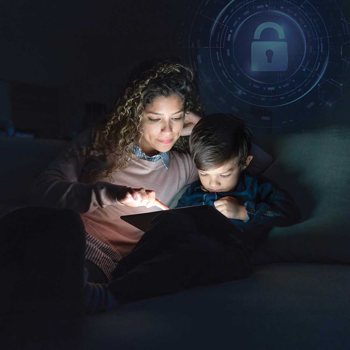 A mother and son sit together in a dimly lit room, focused on a tablet screen, with a digital lock symbol in the background.