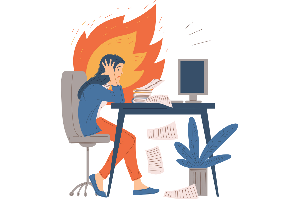 A stressed person sitting at a desk with papers scattered around, facing a computer, with flames in the background.