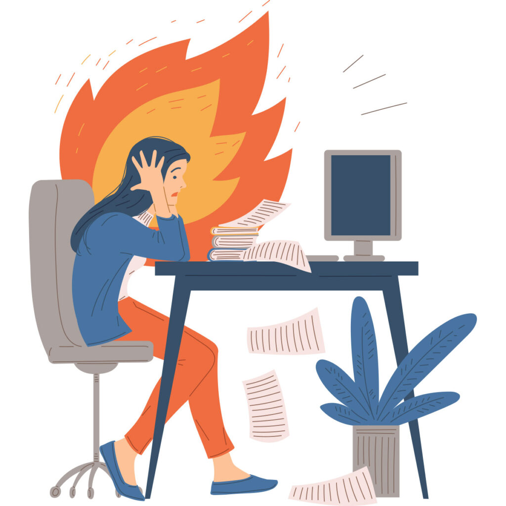 A stressed person sitting at a desk with papers scattered around, facing a computer, with flames in the background.