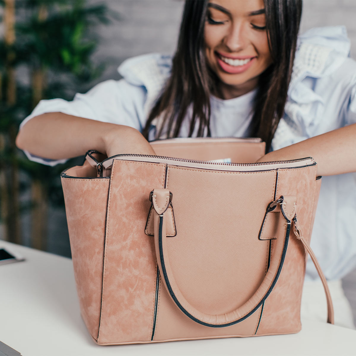 woman looking through her work bag