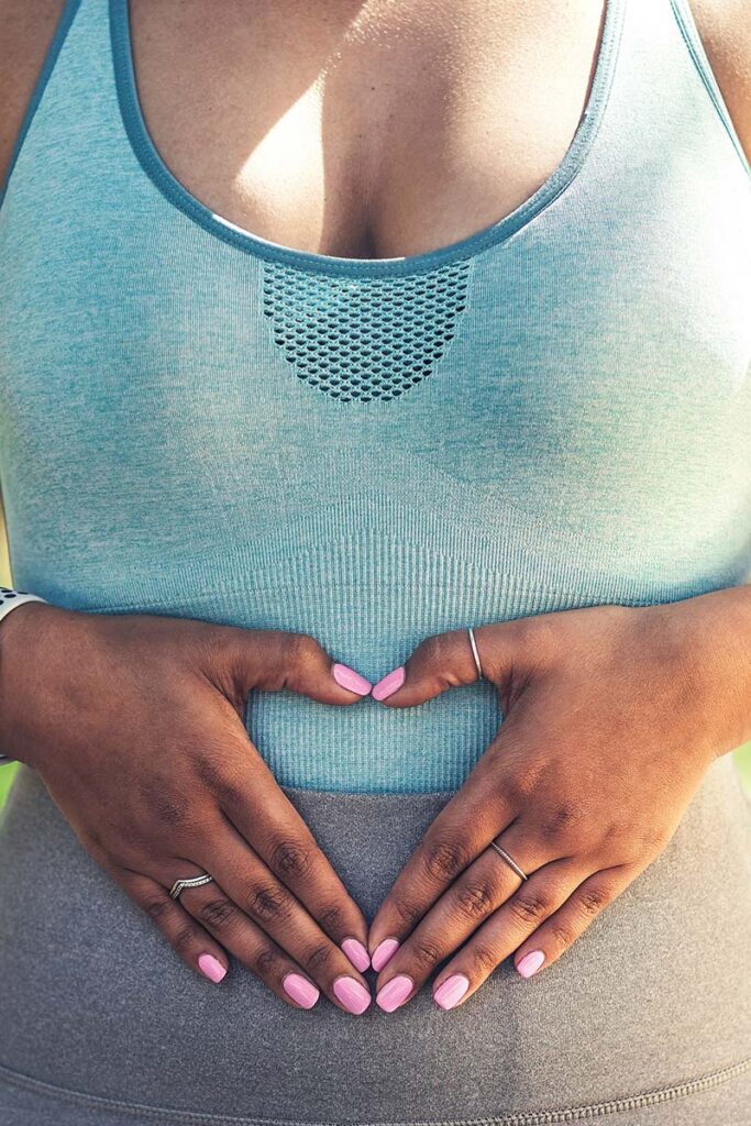 woman with hands on stomach