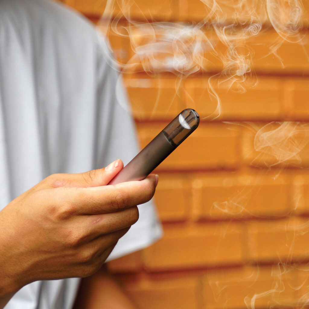 man holding vape