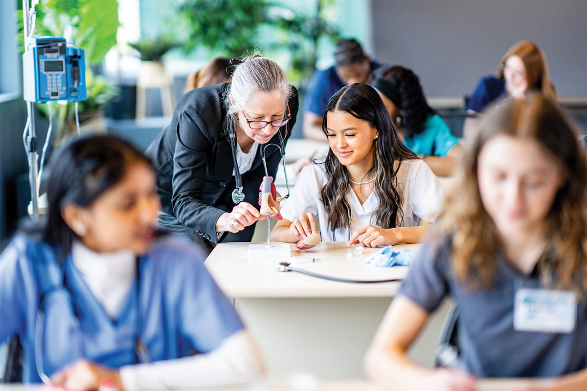 Nursing teacher helping a student