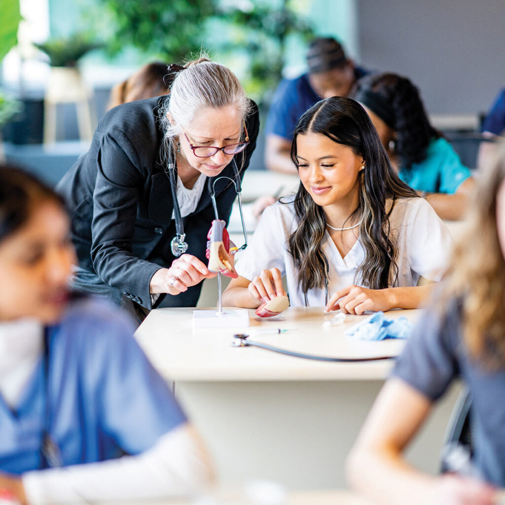 Nursing teacher helping a student