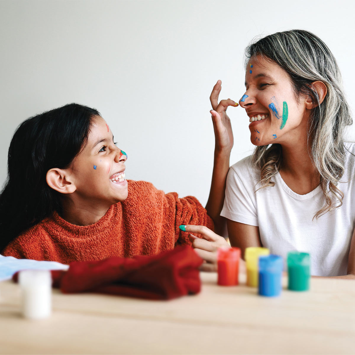 a mother and her daughter playing with paint