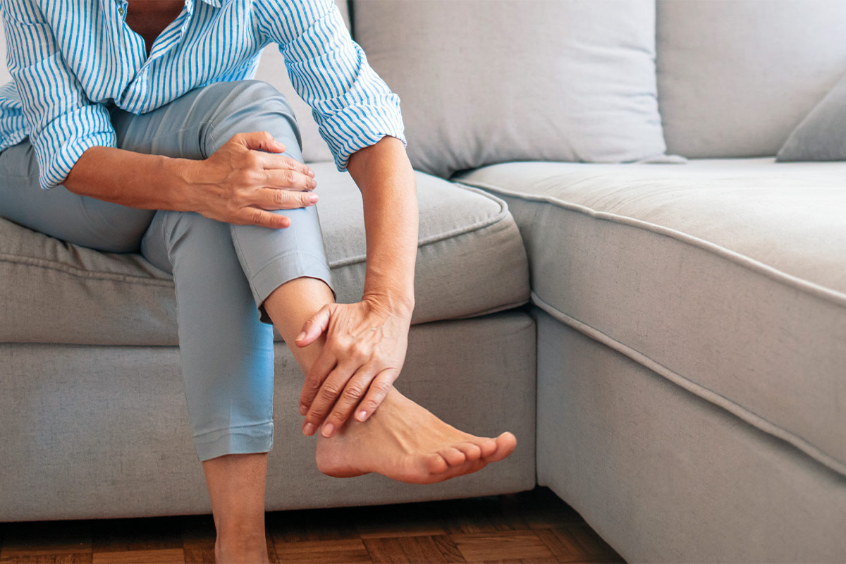 older woman with hand on ankle