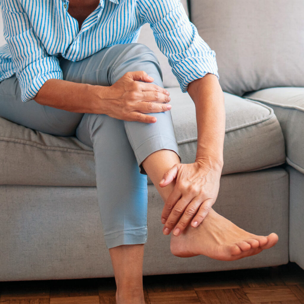 older woman with hand on ankle