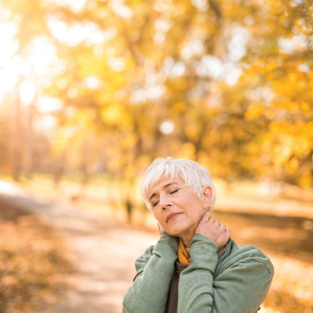 older woman with joint pain in autumn
